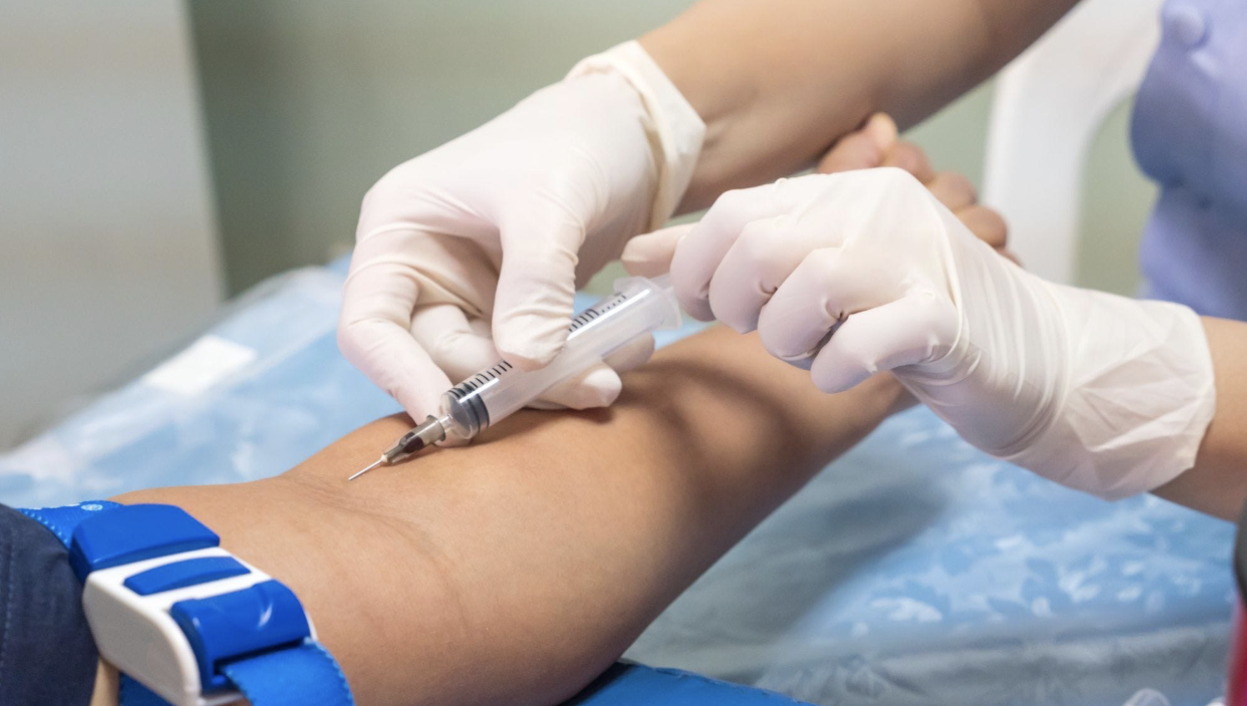 image of nurse drawing blood from patient